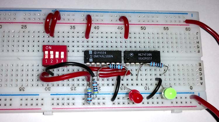 Physical implementation of half adder circuit on breadboard using 74LS86 XOR and 74LS08 AND gate ICs with LED indicators