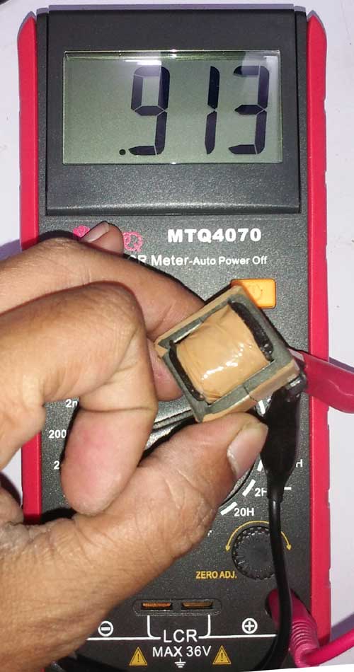 Completed VIPer22A SMPS transformer with E25 ferrite core wrapped in duct tape for vibration damping and mechanical stability