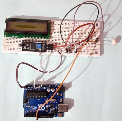 Physical Li-Fi receiver assembly with Arduino UNO, LDR sensor, and 16x2 LCD display on breadboard