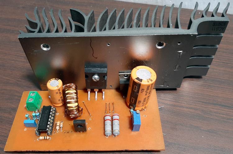 Completed TL494 boost converter circuit board with all components mounted and heat sink attached