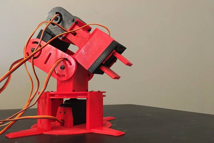 3D-printed 6-axis robotic arm with multiple servo motors mounted on stable base and controlled by Arduino Mega