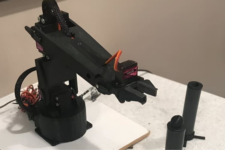 Beginner-friendly 3D-printed robotic arm using SG90 and MG995 servo motors for reliable pick and place