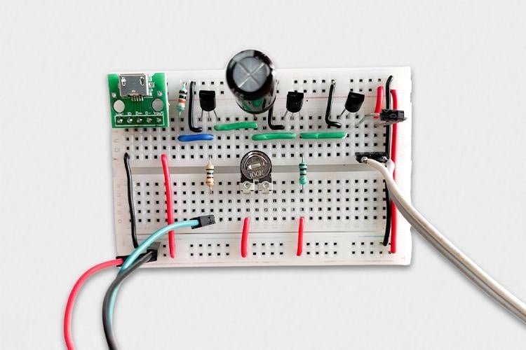 breadboard assembly showing all components of automatic plant watering system including BC547 transistors resistors capacitor and sensor connections